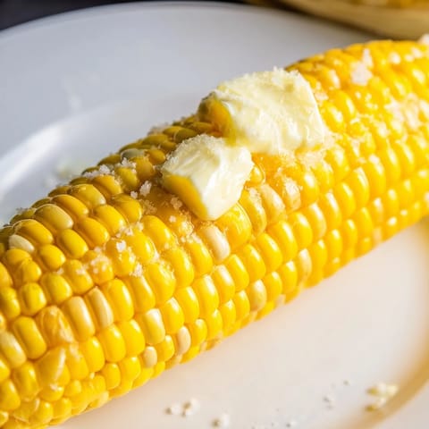 Golden grilled corn on the cob: a simple summer side dish, ready to eat alongside burgers.