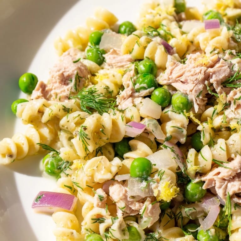 Freshly prepared Lemony Tuna Pasta Salad garnished with parsley, ideal for picnics or a quick weeknight dinner.