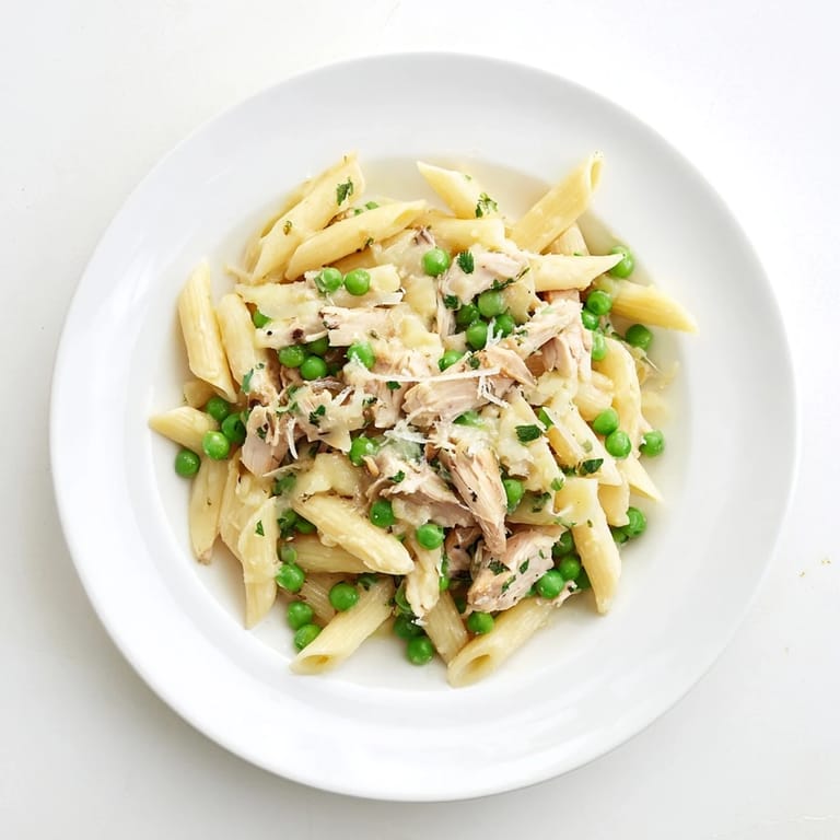 Bright green peas and tender chicken pieces shine in a glossy lemon sauce over penne.  