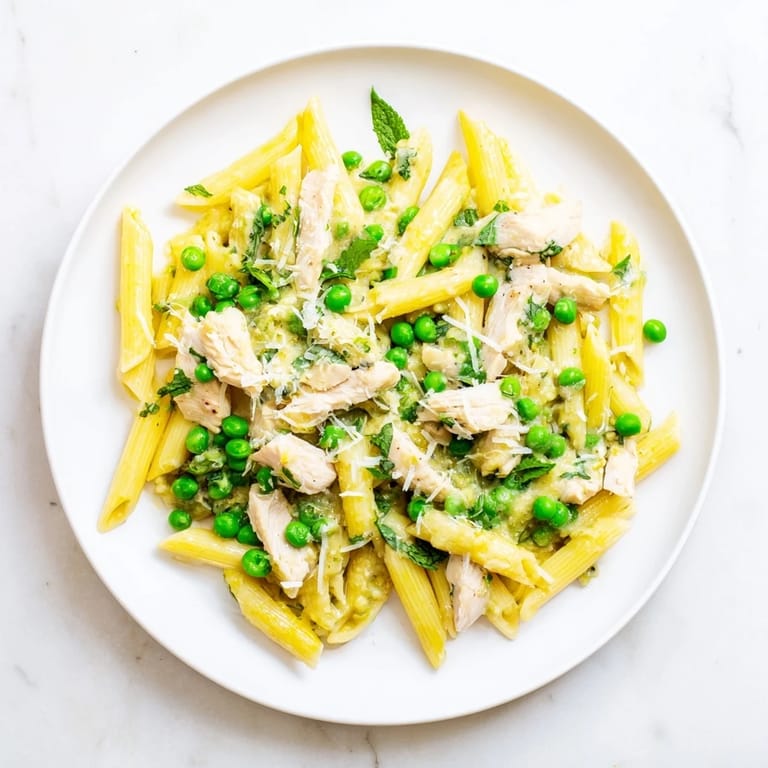 Served hot, this spring-inspired pasta dish looks fresh and inviting on a rustic plate.