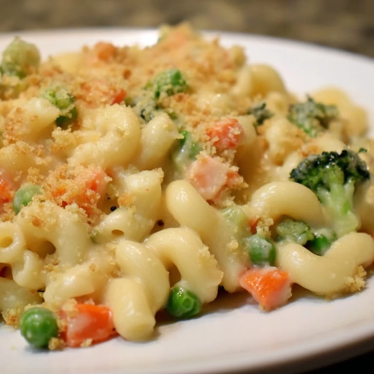 Hearty Garden Veg Mac and Cheese served family-style in a casserole dish, perfect with a crisp green salad for dinner.